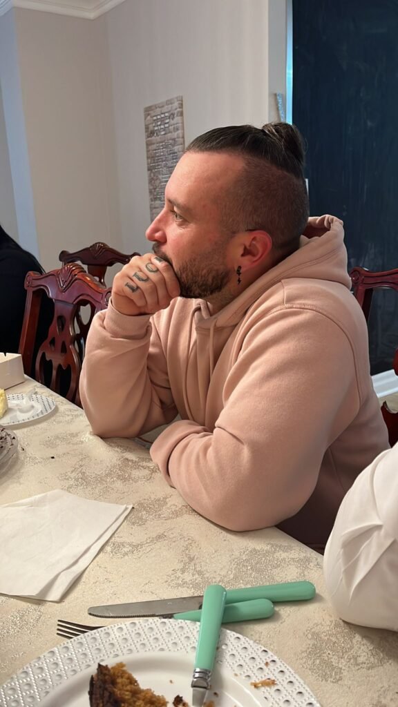 A member of the community at the table during a meal at the Centre