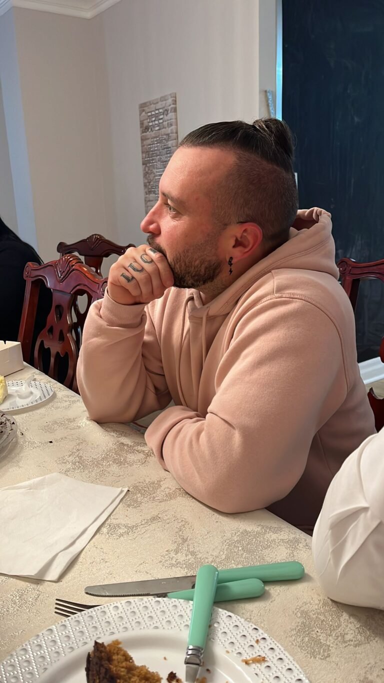 A member of the community at the table during a meal at the Centre