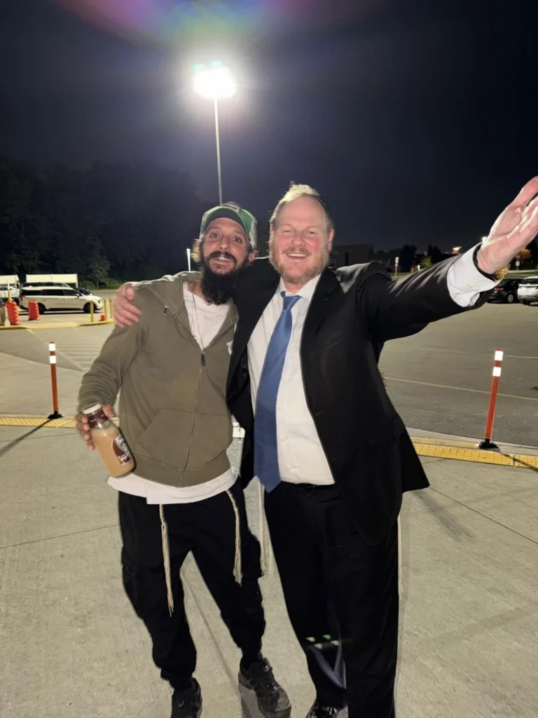 Rabbi MG with a member of the community outside the Centre at night